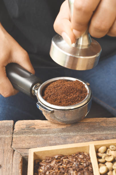 istock Freshly ground coffee beans in a metal filter 875557972