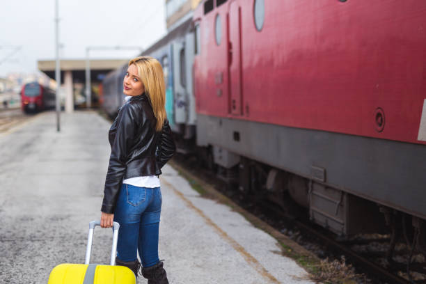 istock Smiling young woman with luggage 875567626