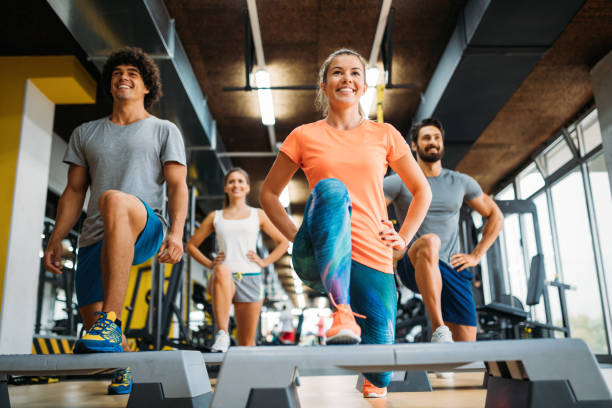 istock Group of young people doing exercises in gym 875567856