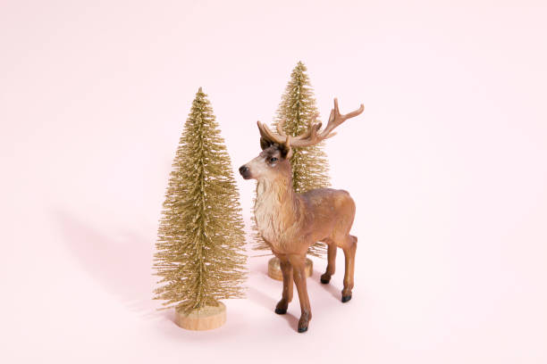 istock golden christmas tree and reindeer pink 875568120