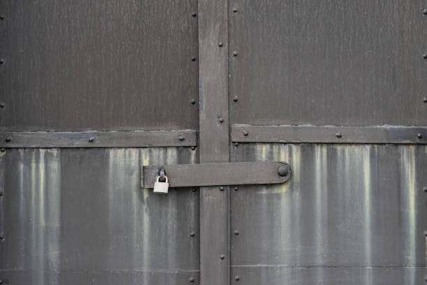 istock the grey steel door with padlock 875568124