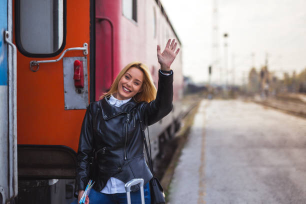 istock Lady on station waving 875568380