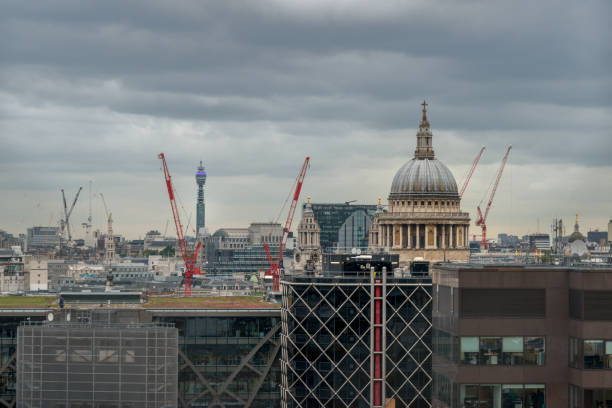 istock Building London.London under construction. The  St Paul's cathedral surrounded by constructions cranes. This image is GPS tagged 875569978