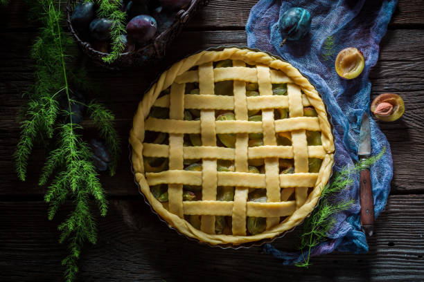 istock Rustic and homemade tart with plums on blue cloth 875574722