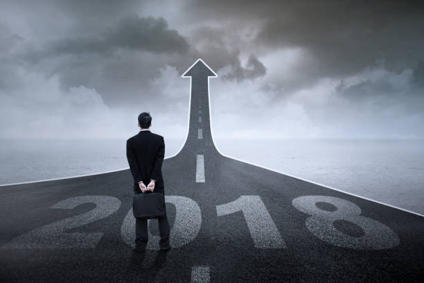 istock Young manager with numbers 2018 and arrow 875575514