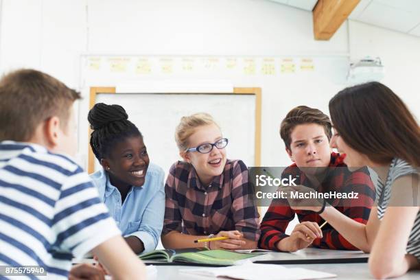 Group Of Teenage Students Collaborating On Project In Classroom Stock Photo - Download Image Now