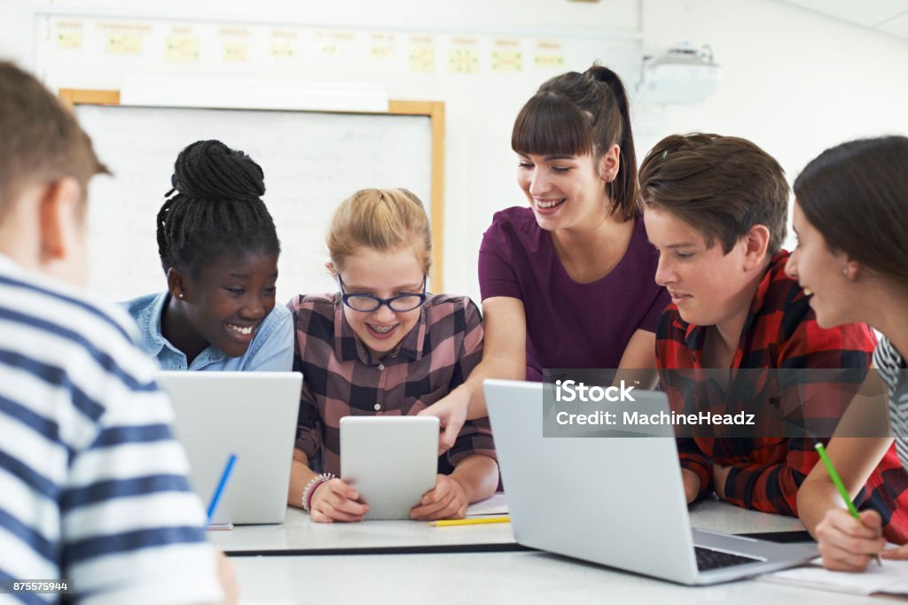 Teenage Students With Teacher In IT Class Classroom Stock Photo