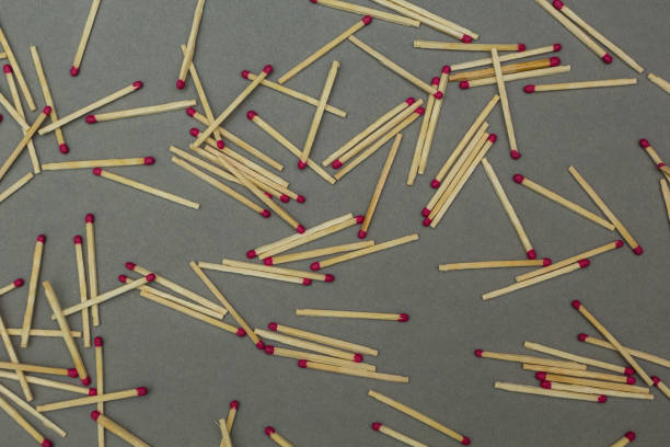 istock Wooden matches scattered on a gray background. 875579042
