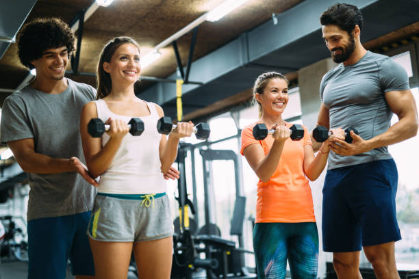 istock Young beautiful women doing exercises with personal trainers 875579610