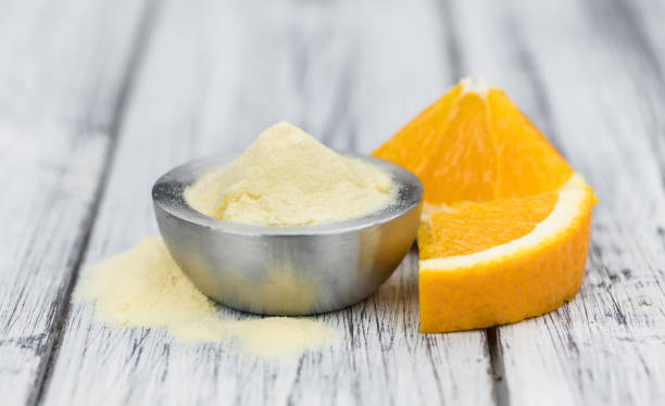 istock Wooden table with orange fruit powder (selective focus) 875583446