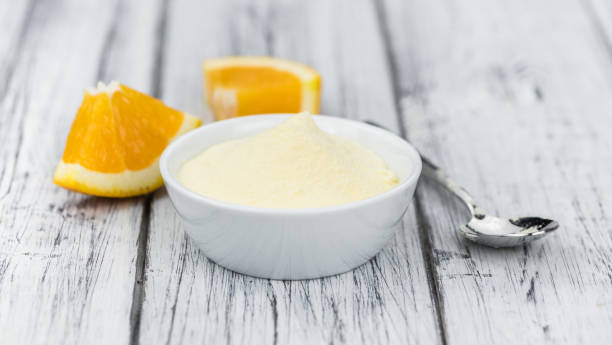 istock Wooden table with orange fruit powder (selective focus) 875583616