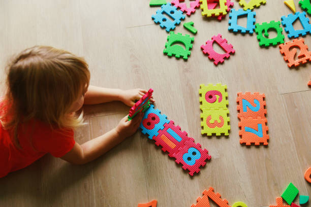 istock little girl learning numbers, education concept 875591490