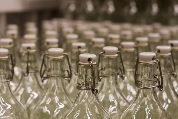 istock Photo close up many empty glass transparent  swing top bottle 875602584
