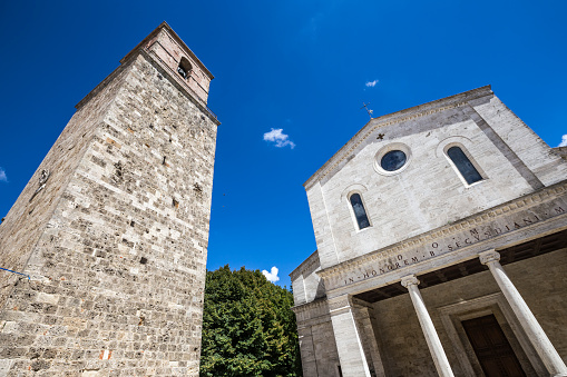 Detail of the bell tower and the facade of the Duomo San Secondiano in Chiusi, in Siena, Italy.