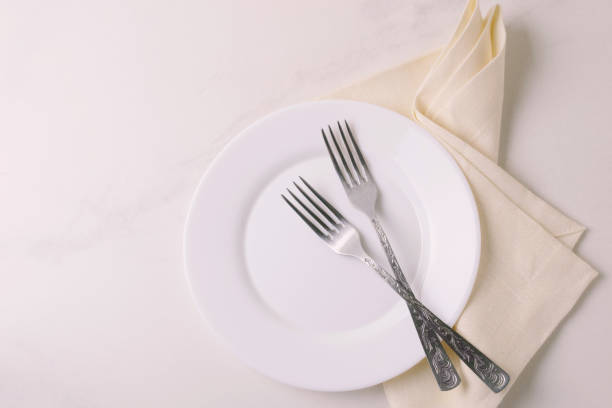 istock Food background. White empty plate, cutlery, napkin. Top view, copyspace. 875618798
