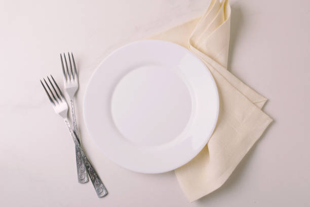 istock Food background. White empty plate, cutlery, napkin. Top view, copyspace. 875618860