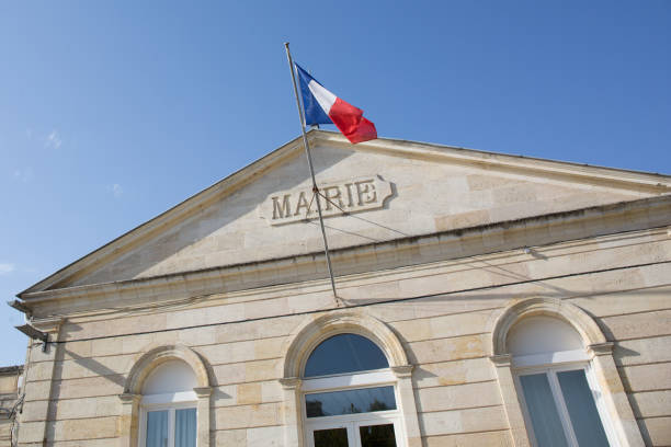 the front of a town hall in a blue sky in France, mairie means town hall The Town Hall of mairie in french means cityhall town hall government building photos stock pictures, royalty-free photos & images
