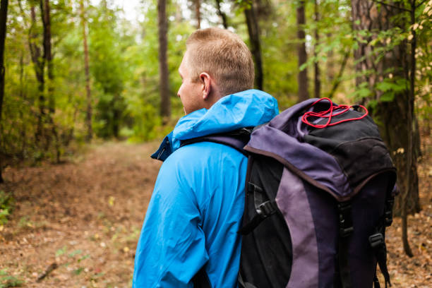 istock Hiker with backpack is walking in the autumn forest. 875633322