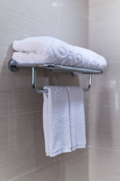 istock Hotel bathroom. Folded white towels on metal rack. 875636052