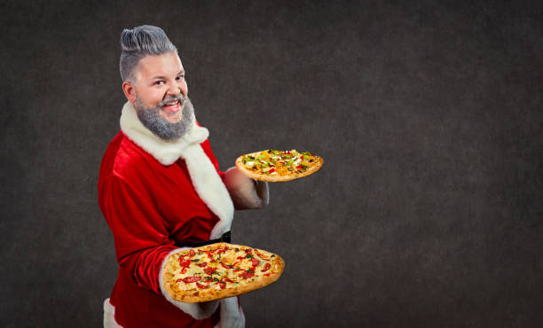 istock Santa Claus with pizza in hands. 875639646