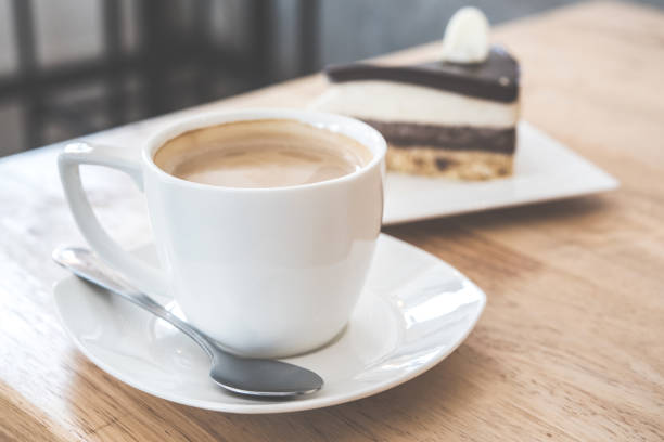 istock Latte coffee and cake on wooden table in cafe. 875640674