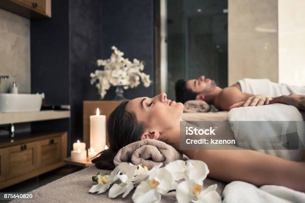 Man And Woman Lying Down On Massage Beds At Asian Wellness Center Stock Photo - Download Image Now