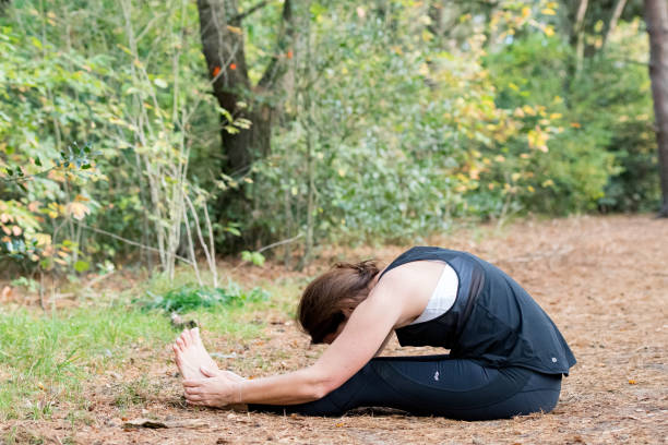 istock Woman practicing yoga in the sand 875647542