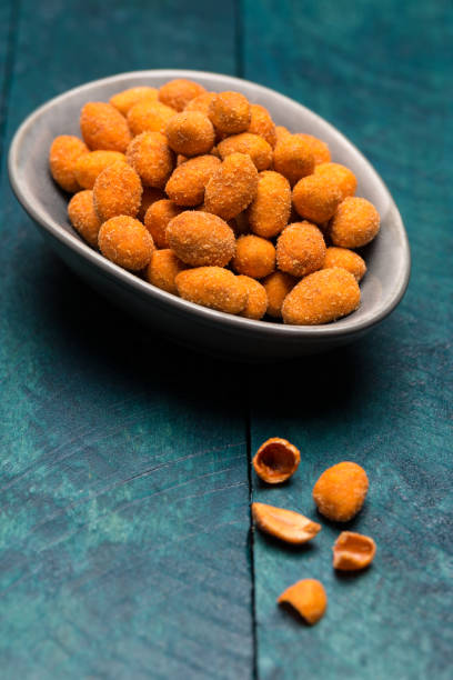 istock Peanuts in batter on petrol wood in bowl 875650358