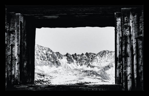 View of Mountains Through Abandoned Building Window View of Mountains Through Abandoned Building Window. Old Abandoned Mining Buildings and Starry Milky Way Stars - Old cabins and night sky with stars and winter mountain view. tenmile range stock pictures, royalty-free photos & images