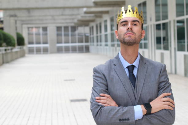 istock Arrogant businessman with crown in office space 875650936