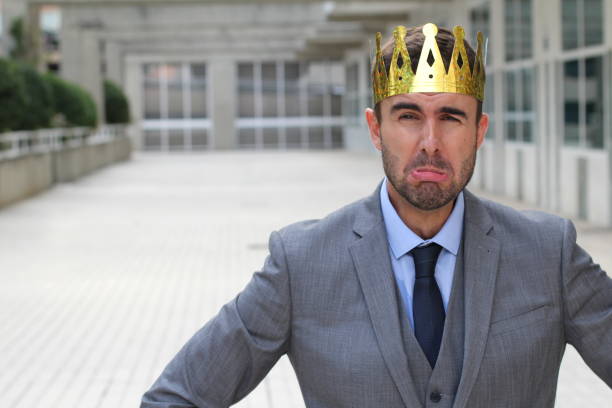 istock Businessman wearing a crown crying with copyspace 875651014