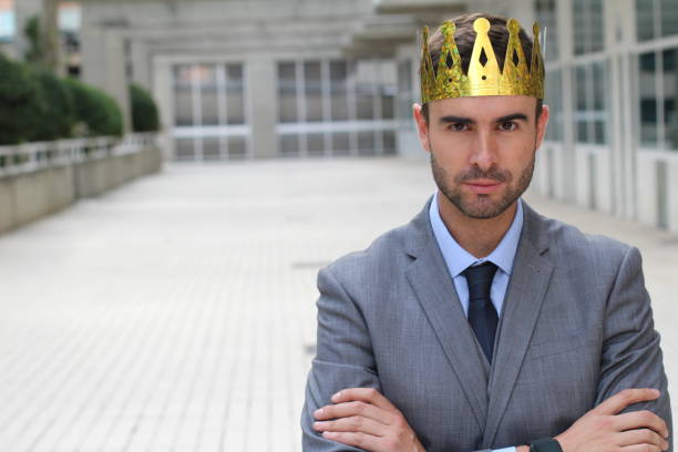 istock Arrogant businessman with crown in office space 875651016