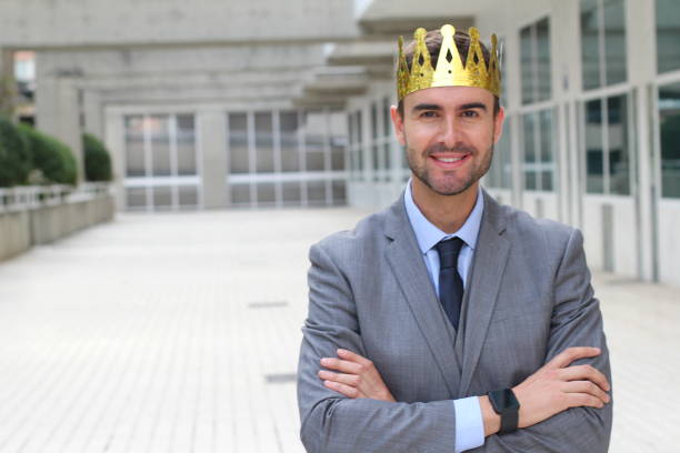 istock Happy businessman with crown in office space 875651028