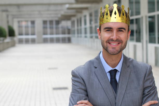 istock Happy businessman with crown in office space 875651094