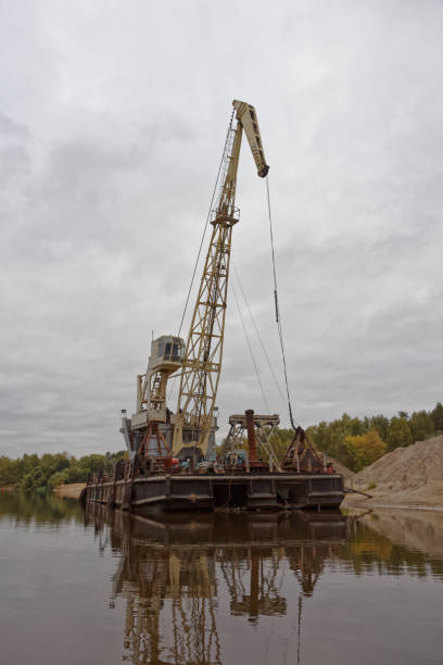 istock Floating crane and piles of sand 875651810