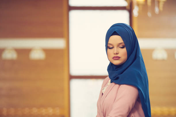 istock muslim woman praying in mosque 875652104