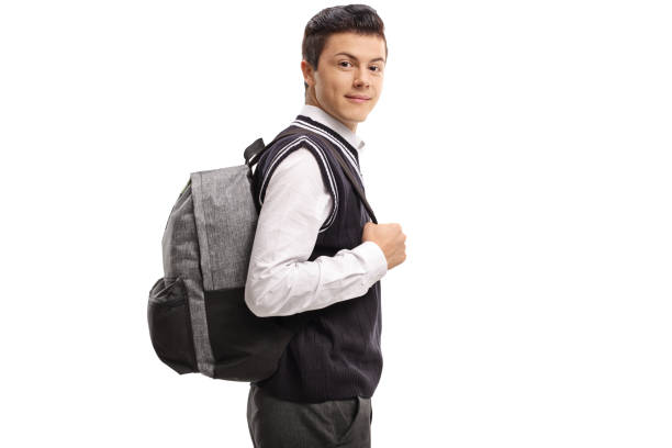 Teenage student with a backpack looking at the camera and smiling isolated on white background