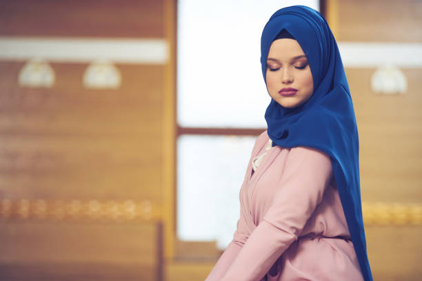 istock muslim woman praying in mosque 875654446