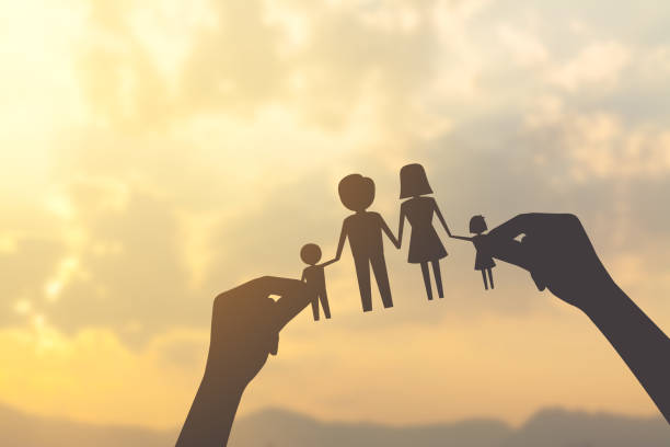silhouette hand holding paper of family stock photo