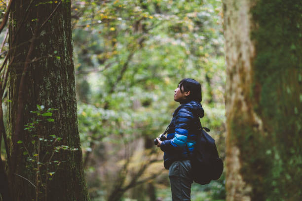 istock Young Woman Taking Photos In Nature 875658372
