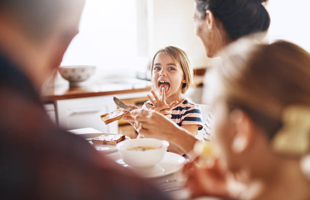 It's finger licking good Cropped shot of a family enjoying breakfast together breakfast stock pictures, royalty-free photos & images