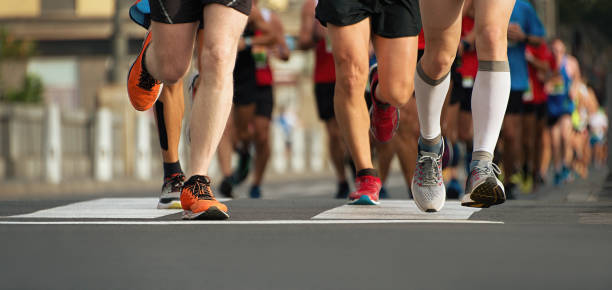 istock Marathon runners running on city road 875663086