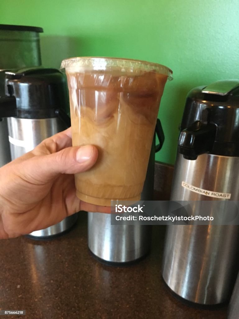 Holding my ice coffee as my daily routine Holding up my ice coffee my daily routine. Male hand holding up ice coffee drink 20-24 Years Stock Photo