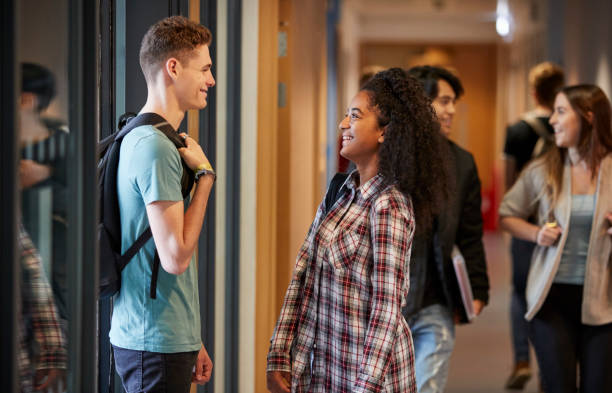 istock Group Of College Students Walking Through College Corridor 875669130