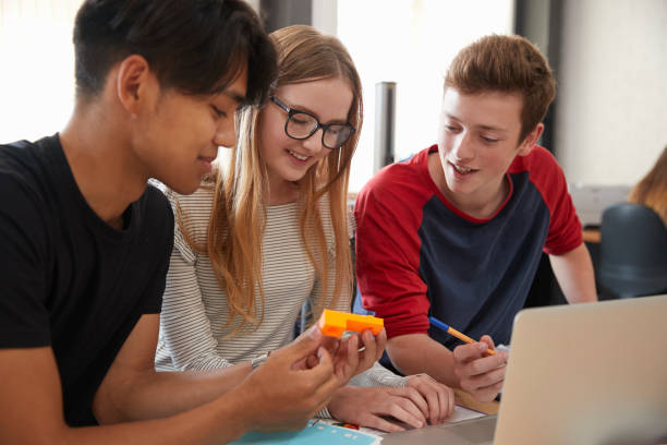 istock Design Students Working In CAD/3D Printing Lab Together 875669132