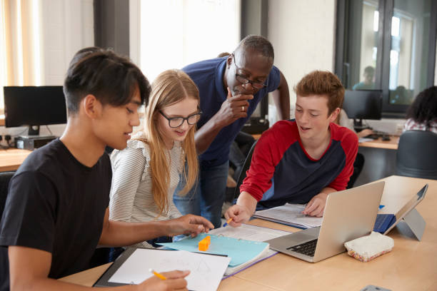 istock Design Students With Teacher Working In CAD/3D Printing Lab 875669152