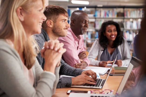 istock Group Of Mature College Students Collaborating On Project 875669232