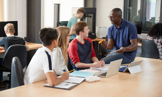 istock Design Students With Teacher Working In CAD/3D Printing Lab 875671500