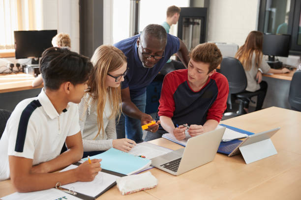 istock Design Students With Teacher Working In CAD/3D Printing Lab 875672338