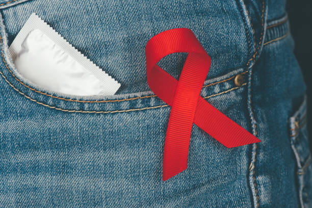 istock condom and aids ribbon 875672838